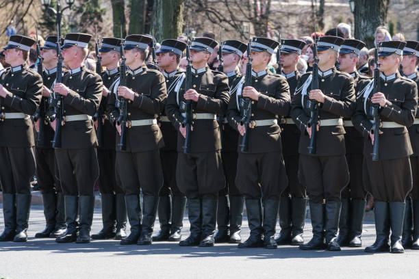 Riga, Latvia - May 4, 2017: The guard of honor standing still next to the Monument of Freedom on the Proclamation Day of the Republic of Latvia on 18th of November and watching the ceremony of flower placing next to the monument.