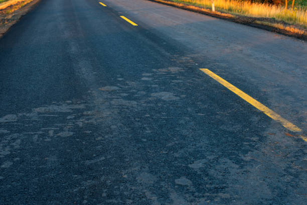 istock Mud trails from tractor tires on road 823533274