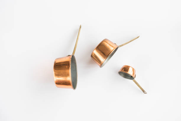 Copper Measuring Cups on a White Background stock photo