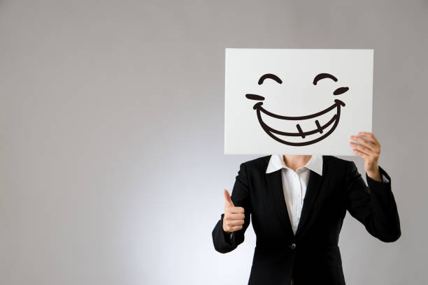 Text of smile with icon on chart paper on wooden background.