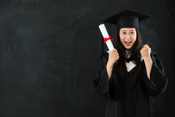 istock graduating student gesturing fist cheerful 823540972