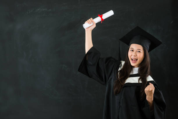 istock cheerful graduate gesturing fist 823541240