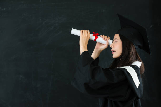istock young happy grad looking through diploma 823541358