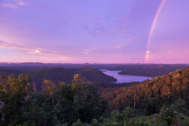 Rainbow at Sunset over Mountain Lake stock photo