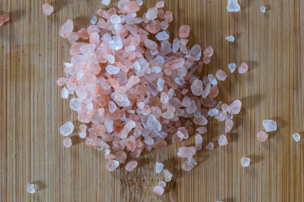 Himalayan Pink Salt on Wooden Cutting Board stock photo