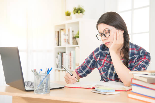 istock bored young woman with laptop computer 823548942