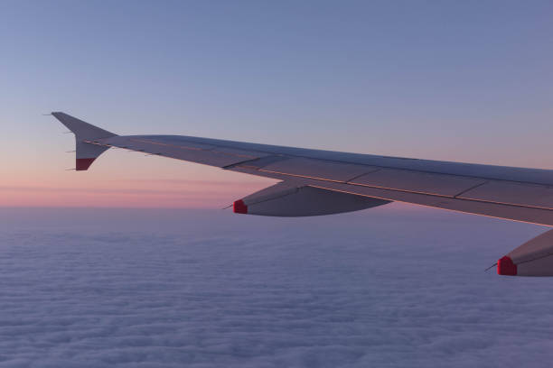 istock Aircraft wing over clouds, flying background clouds over USA 823552728