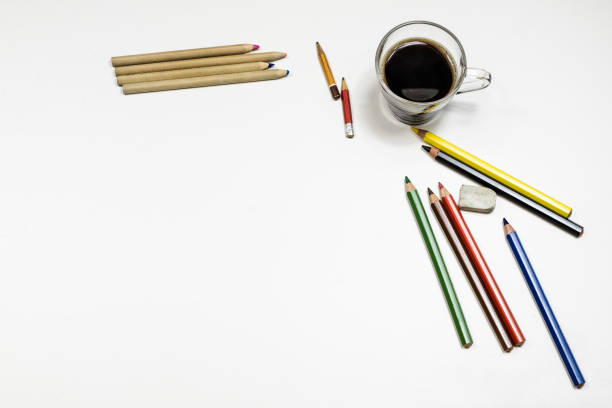 Coffee and sketchbook for drawings. White table. Isolated background. White background.