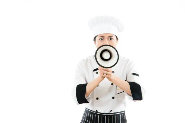 serious chef holding the loud public megaphone