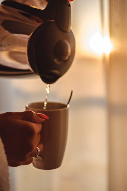 istock Woman making her  coffee in the sunny morning 823559018