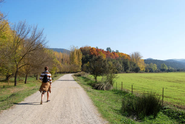 Young man hiking on Via Verde Sierra Norte de Sevilla Greenway in the heart of Sierra Norte de Sevilla Natural Park that follows the old railway line throughout Cerro del Hierro mining area and river Hueznar. via verde spain stock pictures, royalty-free photos & images