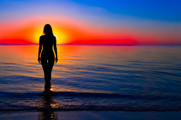 istock Woman silhouette on water 823573876