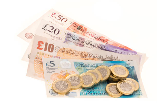 istock British currency banknotes and one pound coins 823576148