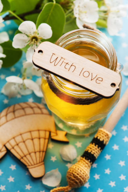 istock Honey with blossoms and wooden spoon 823585914