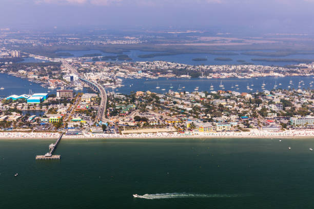 Fishing Pier Fort Myers Beach. Aerial view to the large white sandy beach on the Estero Island, Florida Fishing Pier Fort Myers Beach. Aerial view to the large white sandy beach on the Estero Island, Florida fort myers photos stock pictures, royalty-free photos & images