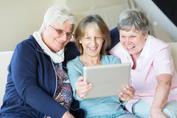 istock Senior women having fun with digital tablet making selfies 823595078