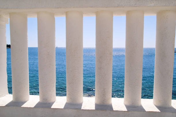 istock Baluster beach. White columns overlooking the sea. View of white pillars and horizont on blue sea and the sky in the background. Travel, swimming, landscape, summertime, Mediterranean, Adriatic sea. 823603230
