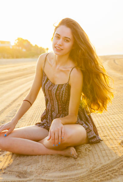istock Young woman posing in the beach sunrise 823603494