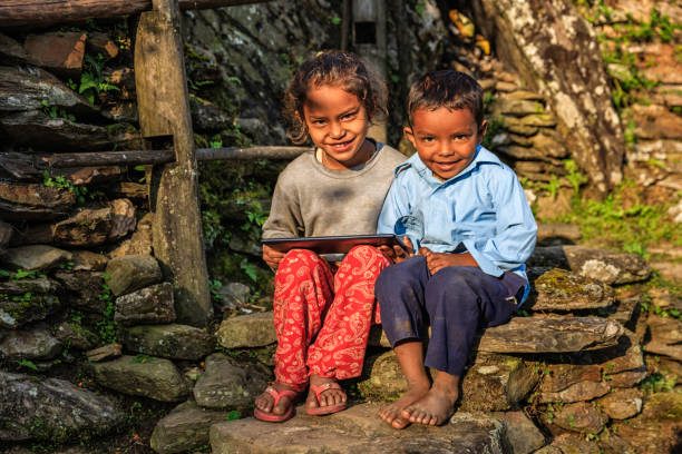 istock Nepali children using digital tablet near Annapurna Range 823605952