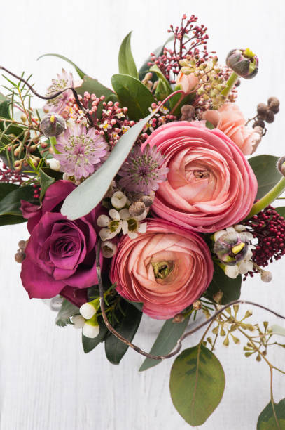 istock Bouquet of flowers in tin mug on light background 823610174