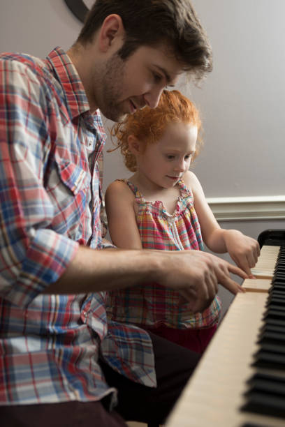 istock Father and Daughter Play Piano 823610944