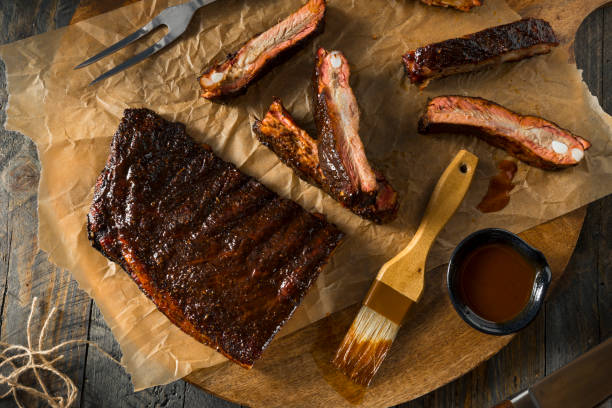 Homemade Smoked Barbecue St. Louis Style Pork Ribs Homemade Smoked Barbecue St. Louis Style Pork Ribs with Sauce ribs stock pictures, royalty-free photos & images