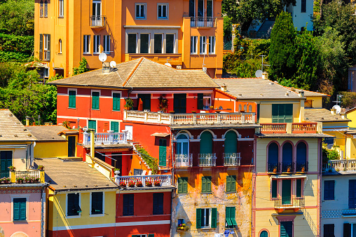 Close view of the colorful houses in Portofino, an Italian fishing village, Genoa province, Italy. A vacation resort with a picturesque harbour and with celebrity and artistic visitors.