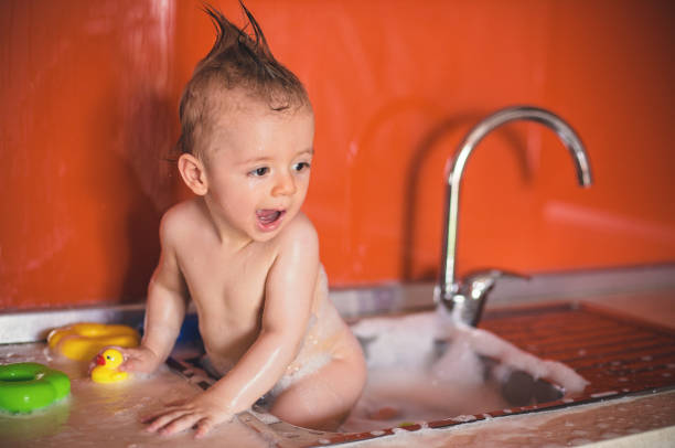 istock Cute Baby Boy taking a bath in Sink 823627754