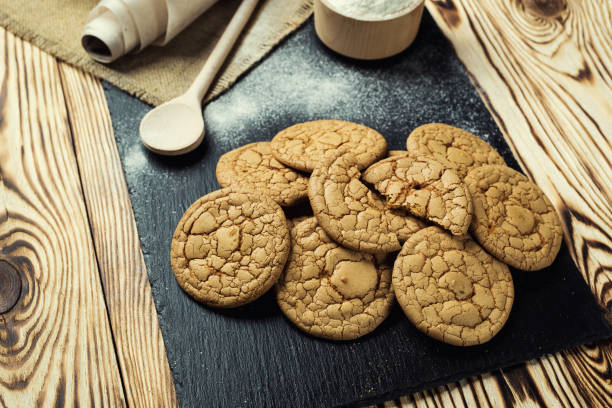 istock Biscuit sweet cookie background. Domestic stacked butter biscuit pattern concept,close up macro.Homemade cookies on wooden table.Cereal biscuits with the sesame,peanuts,sunflower and amaranth. 823628452