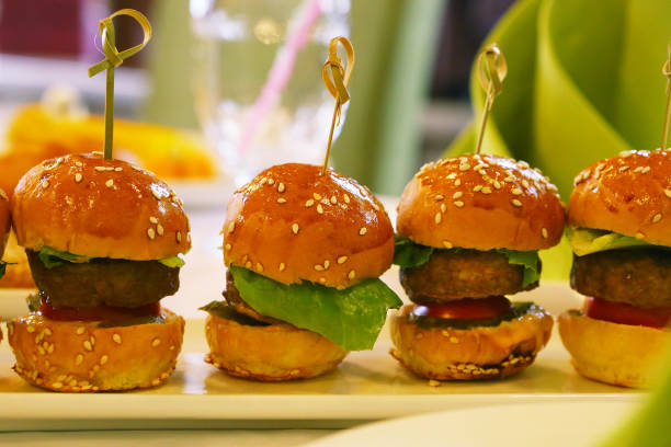 istock mini hamburger with salad leaf served on the plate 823628510
