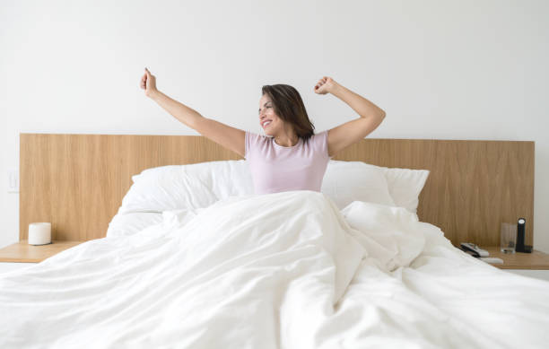 istock Happy woman yawning in bed 823631662