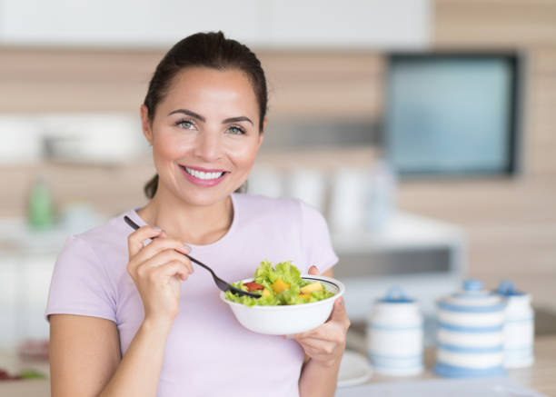 istock Woman eating a healthy salad 823631764