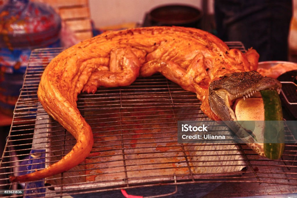 roasted crocodile on asian market roasted crocodile on asian market takeaway food Community Stock Photo