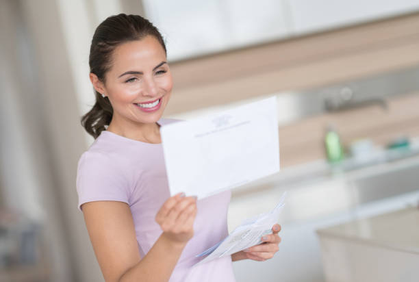 istock Woman at home checking her mail 823631938