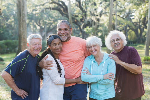 istock Group of five multi-ethnic seniors standing in park 823634630