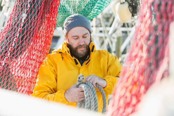 istock Man working on commercial fishing vessel 823634988