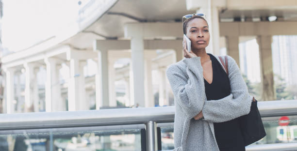 istock Woman standing outdoors and using smart phone 823639884
