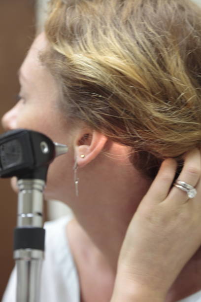istock Examining ear with otoscope. 823640408