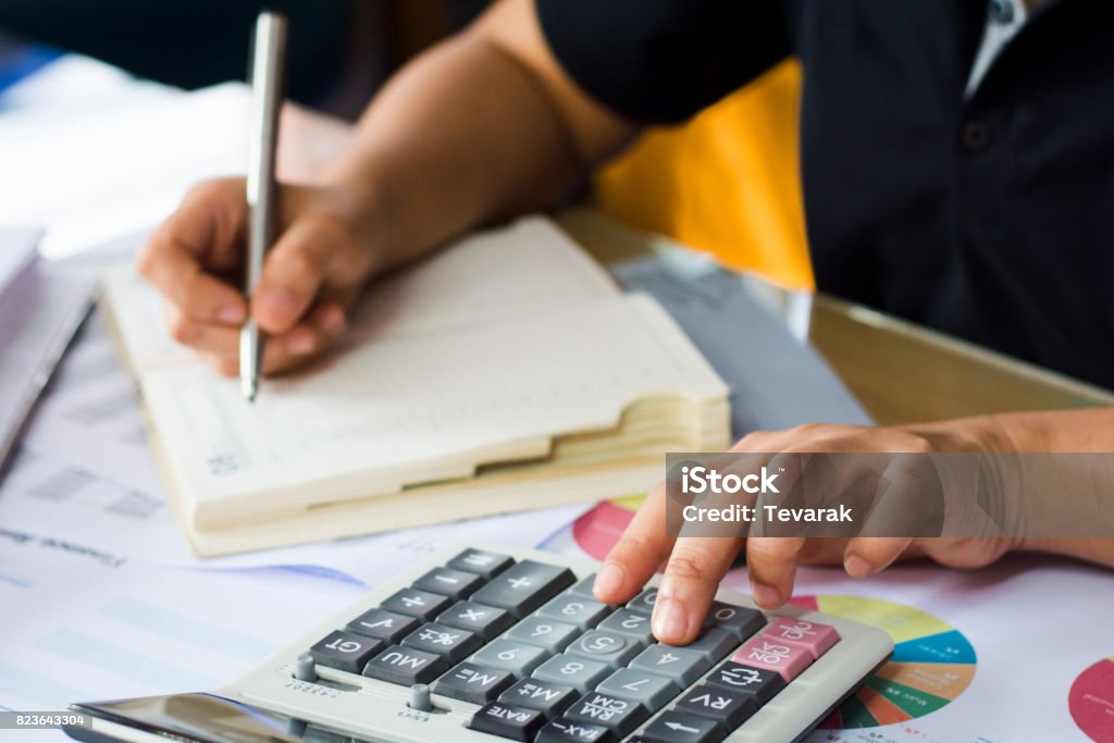 Adults Using Calculators Woman Hand Using Calculator And Writing Make Note With Calculate Stock ...