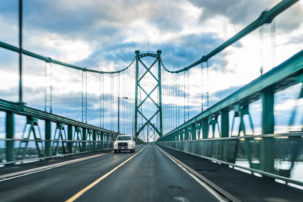 Ile D'orleans: Bridge view crossing Saint Lawrence river from Ile D'Orleans, Quebec to Boischatel during sunset