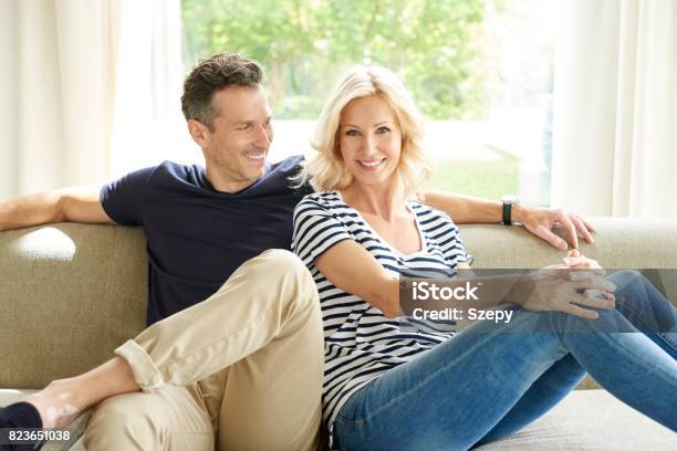 Relaxing Together At Home Stock Photo - Download Image Now - Domestic Life, Mature Couple, Couple - Relationship