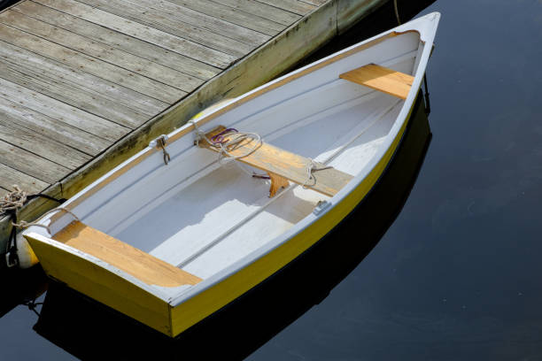 istock Rowboats sit alongside a wooden dock in a small New England Harbor 823654814