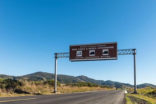 View of the BR 282 with a road sign and the landscape of the 'Serra Catarinense' in Santa Catarina state - Brazil