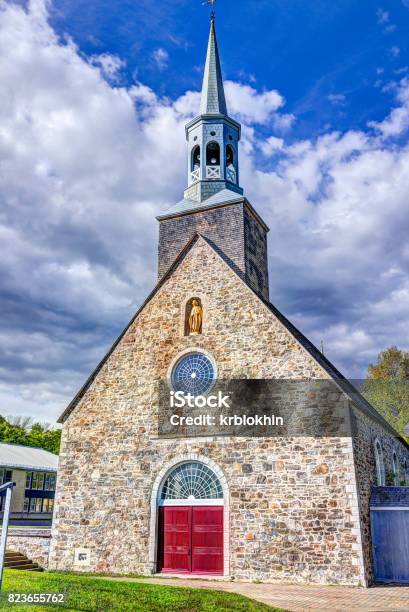 Saintfrancois Red Painted Church With Stone Architecture And Gold Statue Blue Sky In Summer Stock Photo - Download Image Now