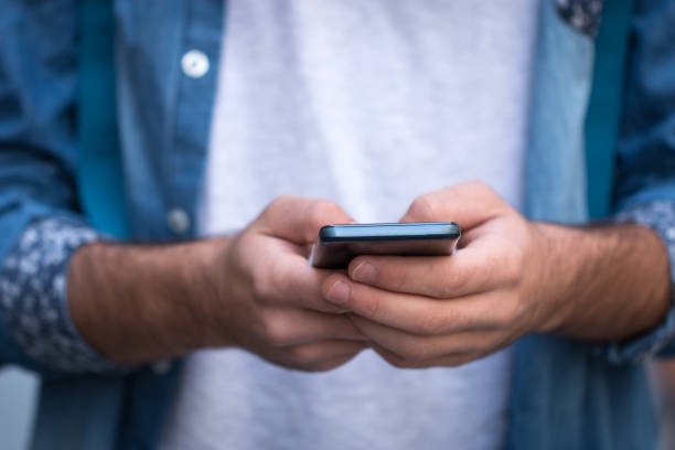 istock Planning my weekend. Handsome young man writes a message on a mobile phone 823655800