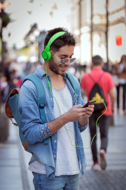 istock Smiling man texting and listening music 823660788