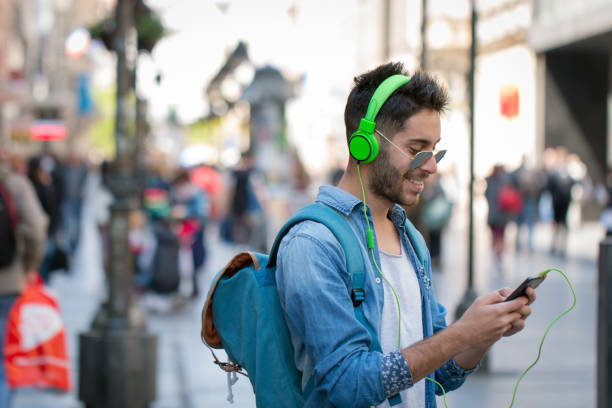 istock Smiling man texting and listening music 823661256