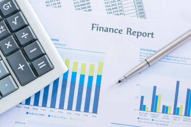 istock Close up pen on finance report and calculator on table office. 823665230