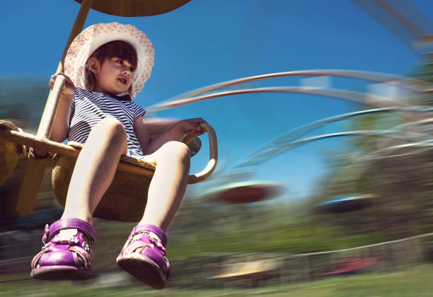 istock Happy girl having fun on the roundabout 823671792