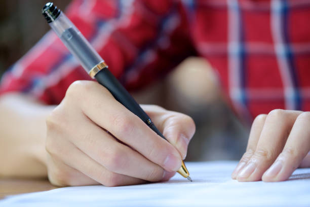 istock Man is signing on a paper. 823671942